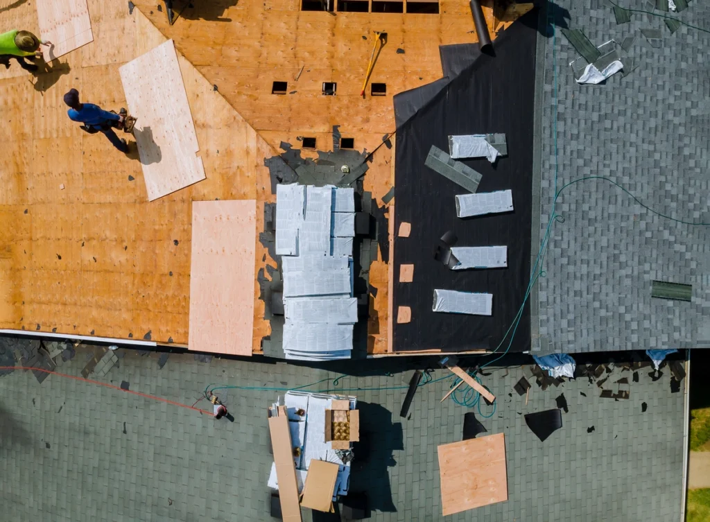 roofers applying new underlayment during a roof replacement ensuring they meet florida roofing underlayment requirements