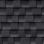 Close-up view of dark gray asphalt roof shingles arranged in a staggered pattern, showing texture and slight variations in shade.