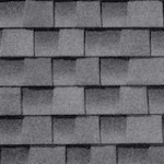 Gray asphalt roof shingles arranged in a neat, overlapping pattern, creating a textured and uniform surface.