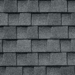 Gray asphalt roof shingles arranged in an overlapping pattern, creating a textured surface commonly seen on residential rooftops.