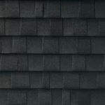 Close-up view of dark gray asphalt roof shingles arranged in a horizontal, overlapping pattern.