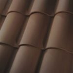 Close-up view of brown, curved roof tiles arranged in neat, overlapping rows, creating a textured and uniform pattern.