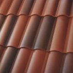 Close-up view of red clay roof tiles arranged in neat, overlapping rows, showing their curved and ridged design.
