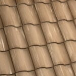 Close-up view of overlapping brown ceramic roof tiles arranged in a uniform pattern, showing subtle weathering and texture.