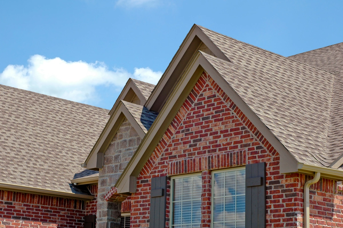 installing roof shingles on a brick home