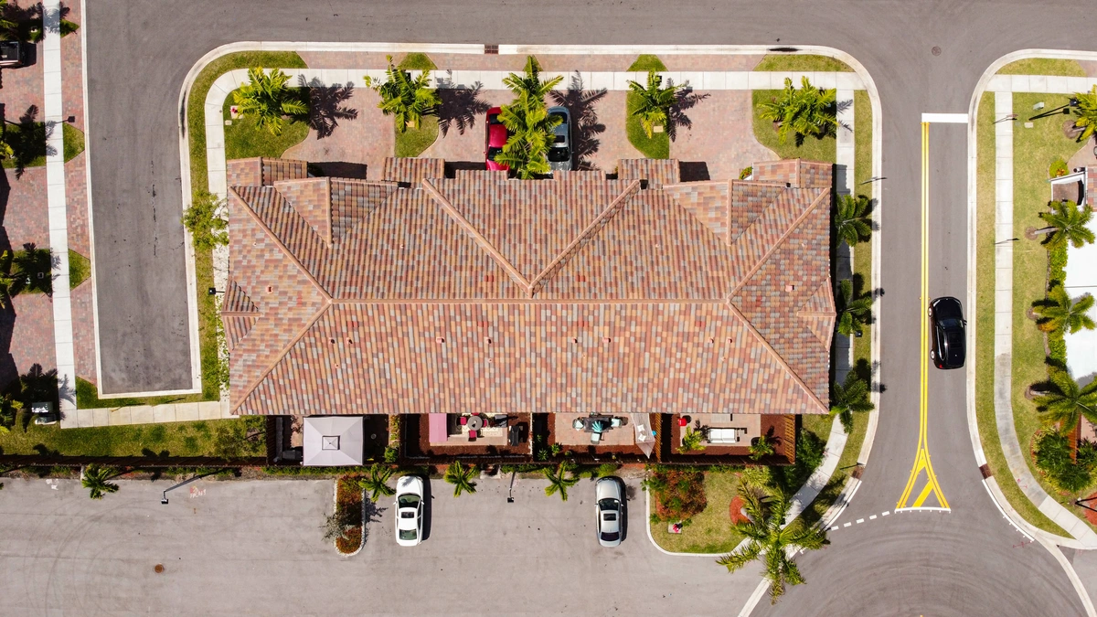 Newly installed large building roof with Palm trees around
