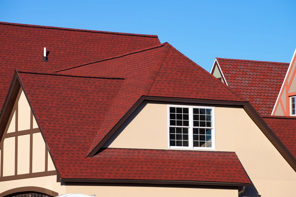 Residential house covered with red shingles