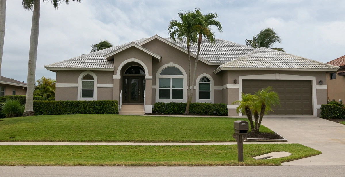 a house surrounded by palm trees