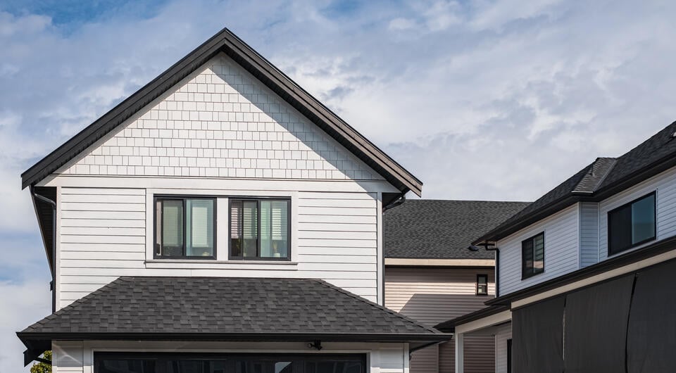 black shingles-white sided house with black architectural shingle roofing