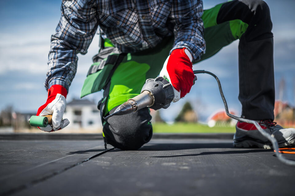 epdm roofing-close up of roofer installing epdm roofing materials