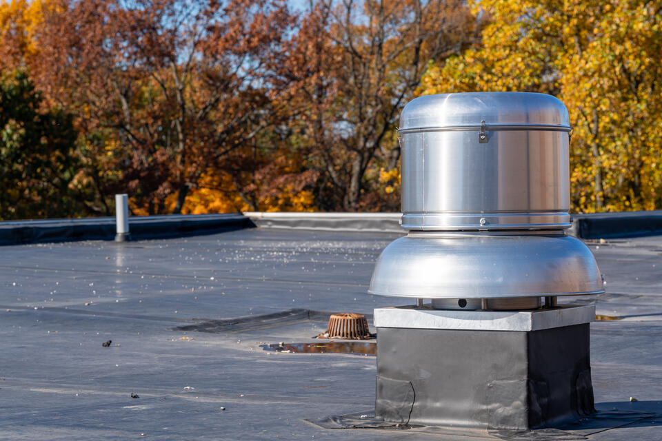 epdm roofing-commercial roof with epdm roofing and fall foliage in the background