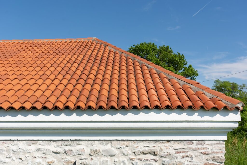 stone residential house with clay tile roof
