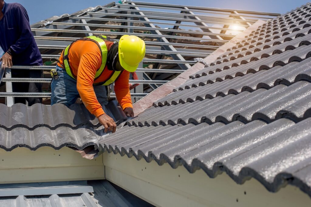 worker installing tile roofing