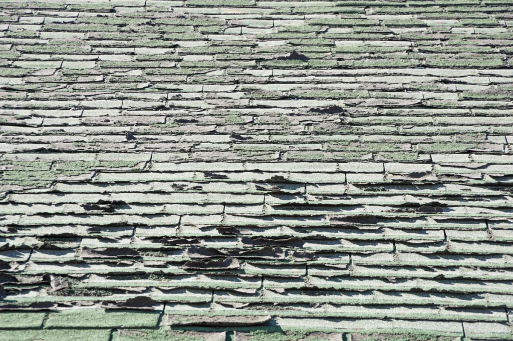 curling roof shingles on home