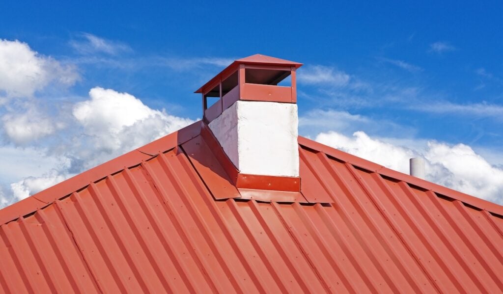 chimney on the roof of the house against the blue sky