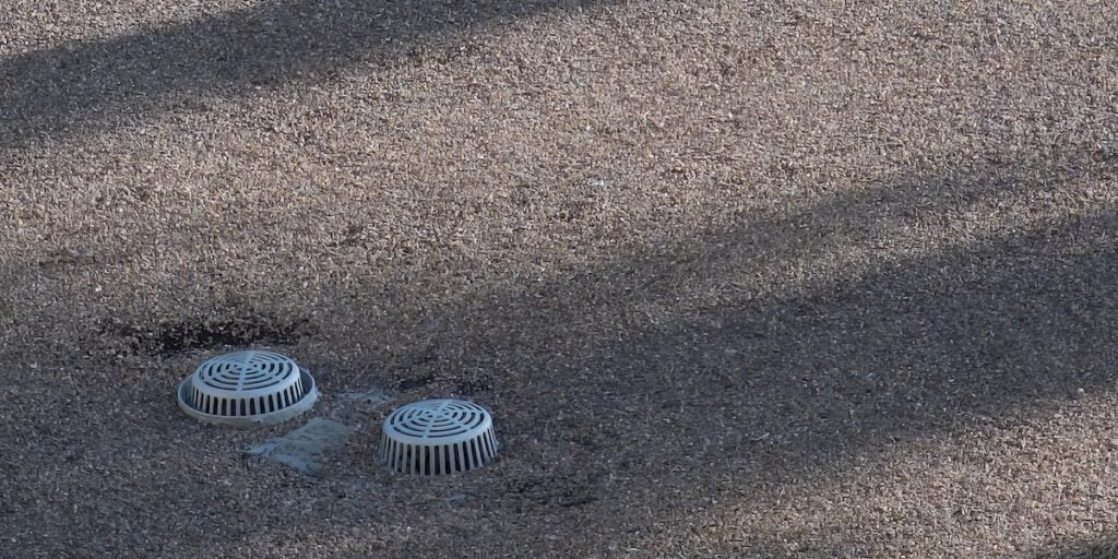 Flat building roof top with ventilation and covered stormwater intake visible. . High quality photo
