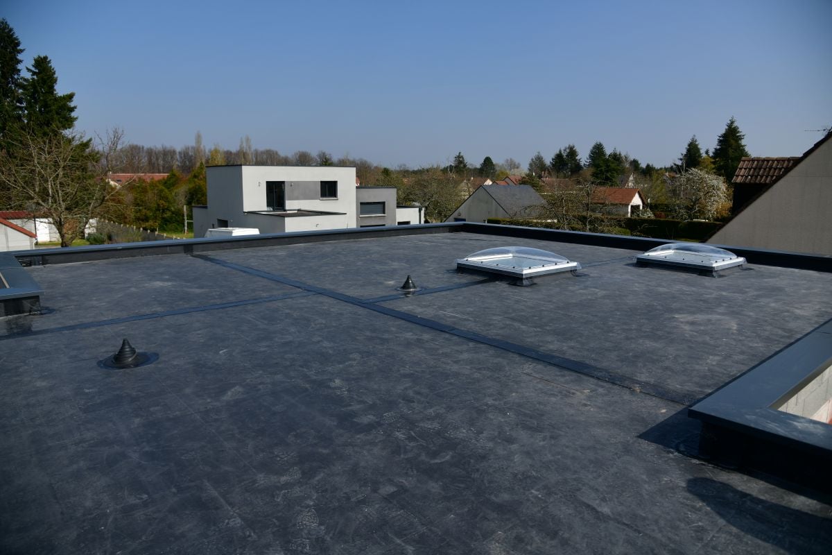 EPDM roof coating commercial building black coat sunny day