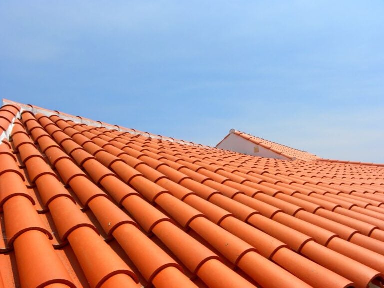 brava roof tile orange tiles house closeup blue sky sunny day
