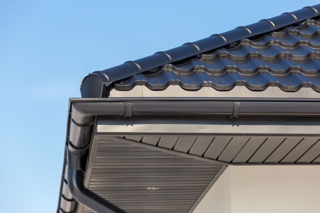 types of gutters grey gutter in modern house closeup blue sky